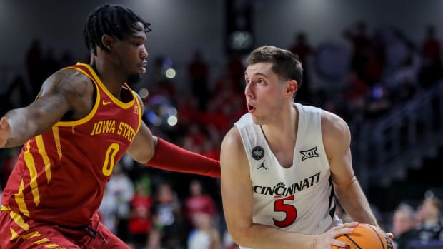 Feb 13, 2024; Cincinnati, Ohio, USA; Cincinnati Bearcats guard CJ Fredrick (5) holds the ball against Iowa State Cyclones forward Tre King (0) in the second half at Fifth Third Arena. Mandatory Credit: Katie Stratman-USA TODAY Sports